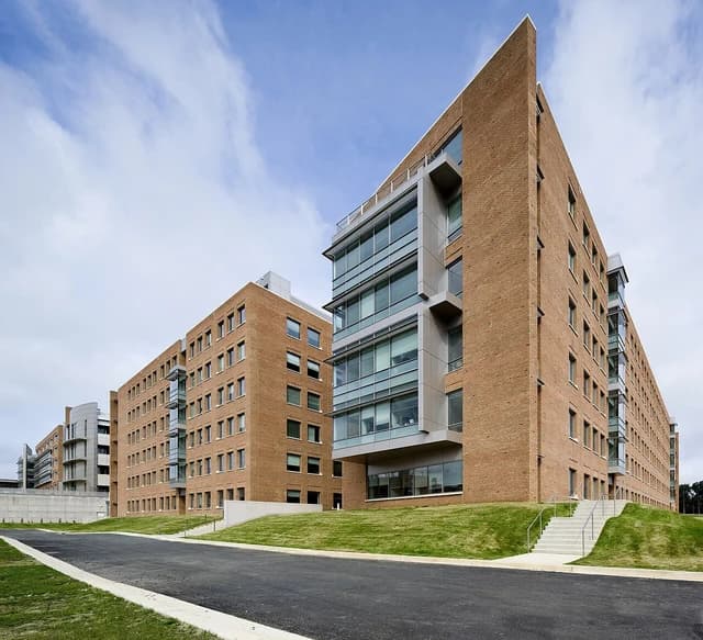 Exterior of the FDA Building 66, CDRH, with a road and green grass in the foreground.