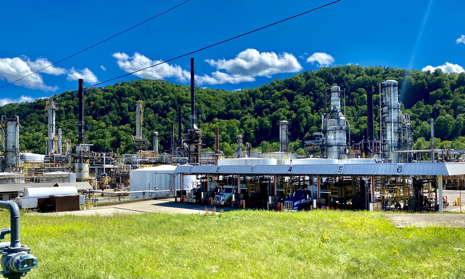 United Oil Refinery with numerous industrial structures and large storage tanks.