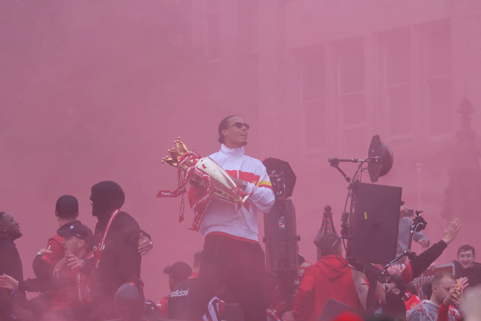 Virgil van Dijk holds the Premier League trophy during a Liverpool victory parade.