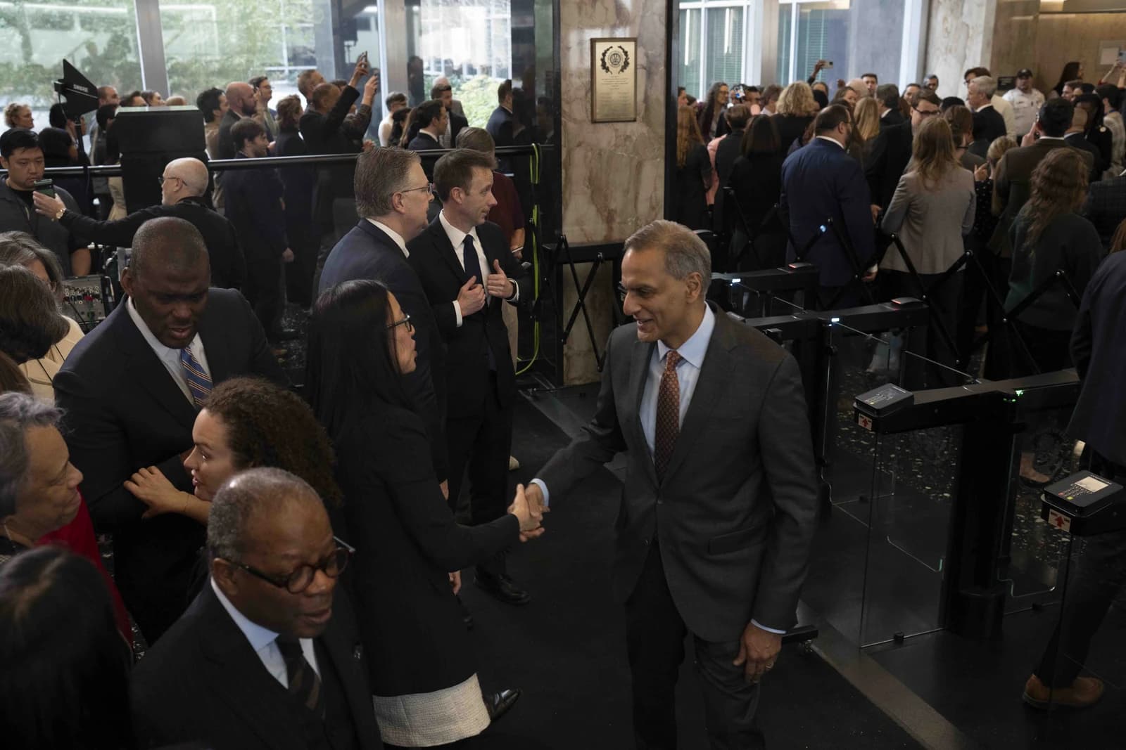 Antony Blinken, Secretary of State, shaking hands with an individual at the U.S. State Department.