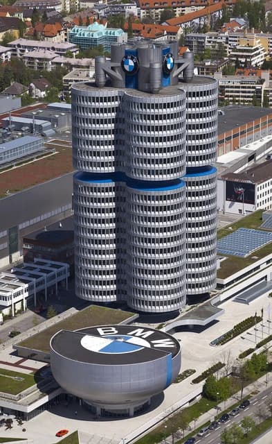 Aerial view of the BMW Headquarters, a four-cylinder-shaped building, next to the BMW Welt exhibition hall in Munich.