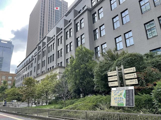 Ministry of Finance building exterior in Tokyo, Japan, with a flagpole displaying the Japanese flag.