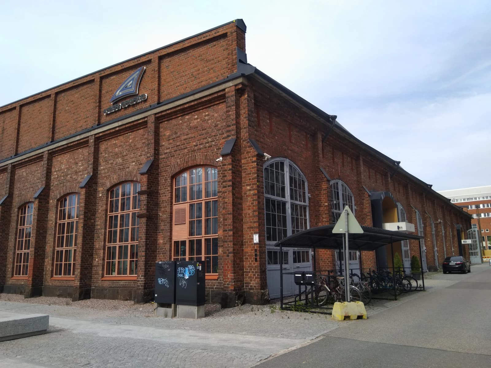 Amer Sports corporate office, a brick building with arched windows, in Helsinki, Finland.