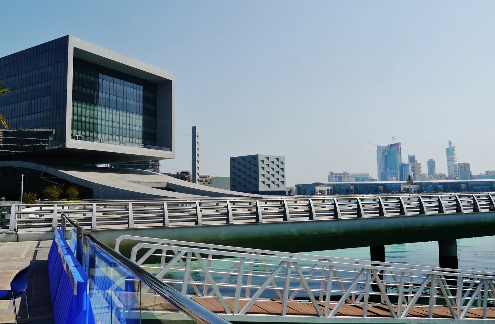 Modern Arcapita Bank building and adjacent waterfront structures in Manama, Bahrain.