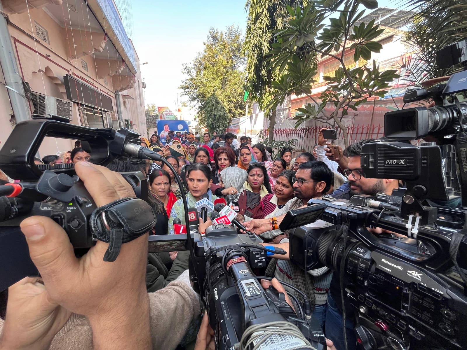 Sarika Singh Choudhary speaking to reporters from various news organizations.