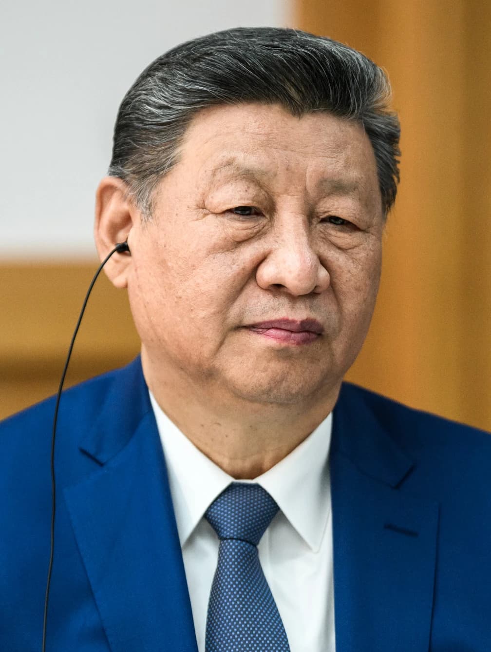 Xi Jinping, President of China, listens attentively during a meeting.