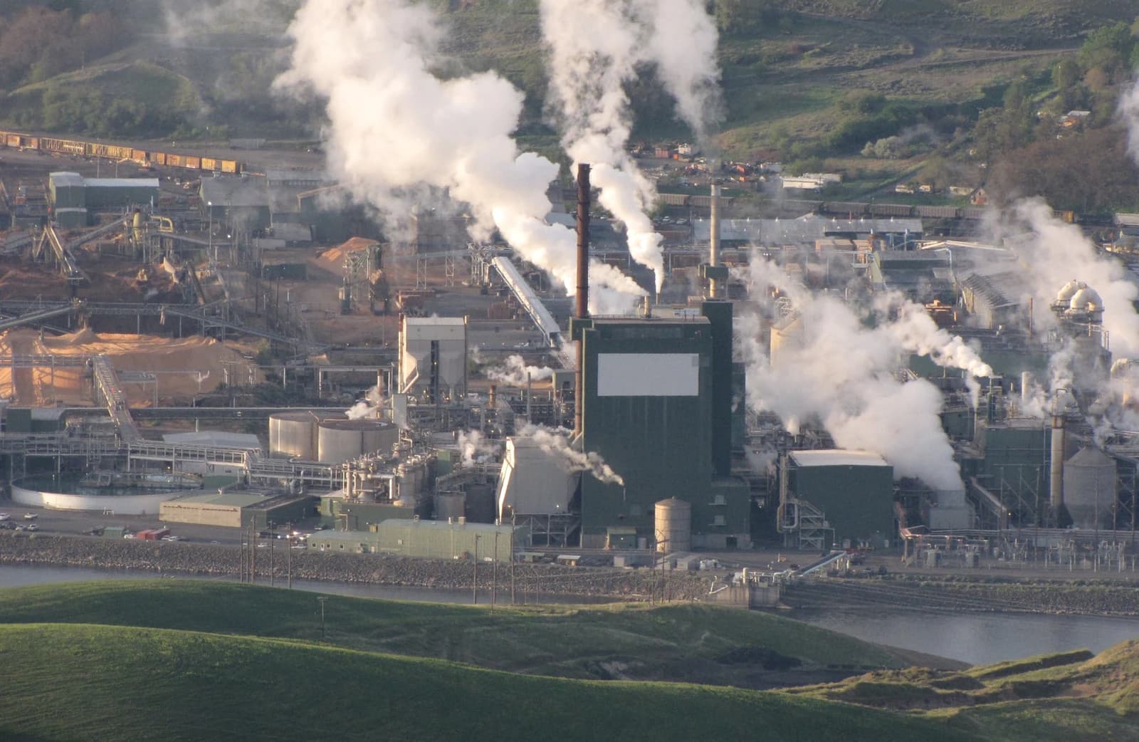 Aerial view of a wood pulp mill with smoke stacks emitting steam, Lewiston, Idaho.