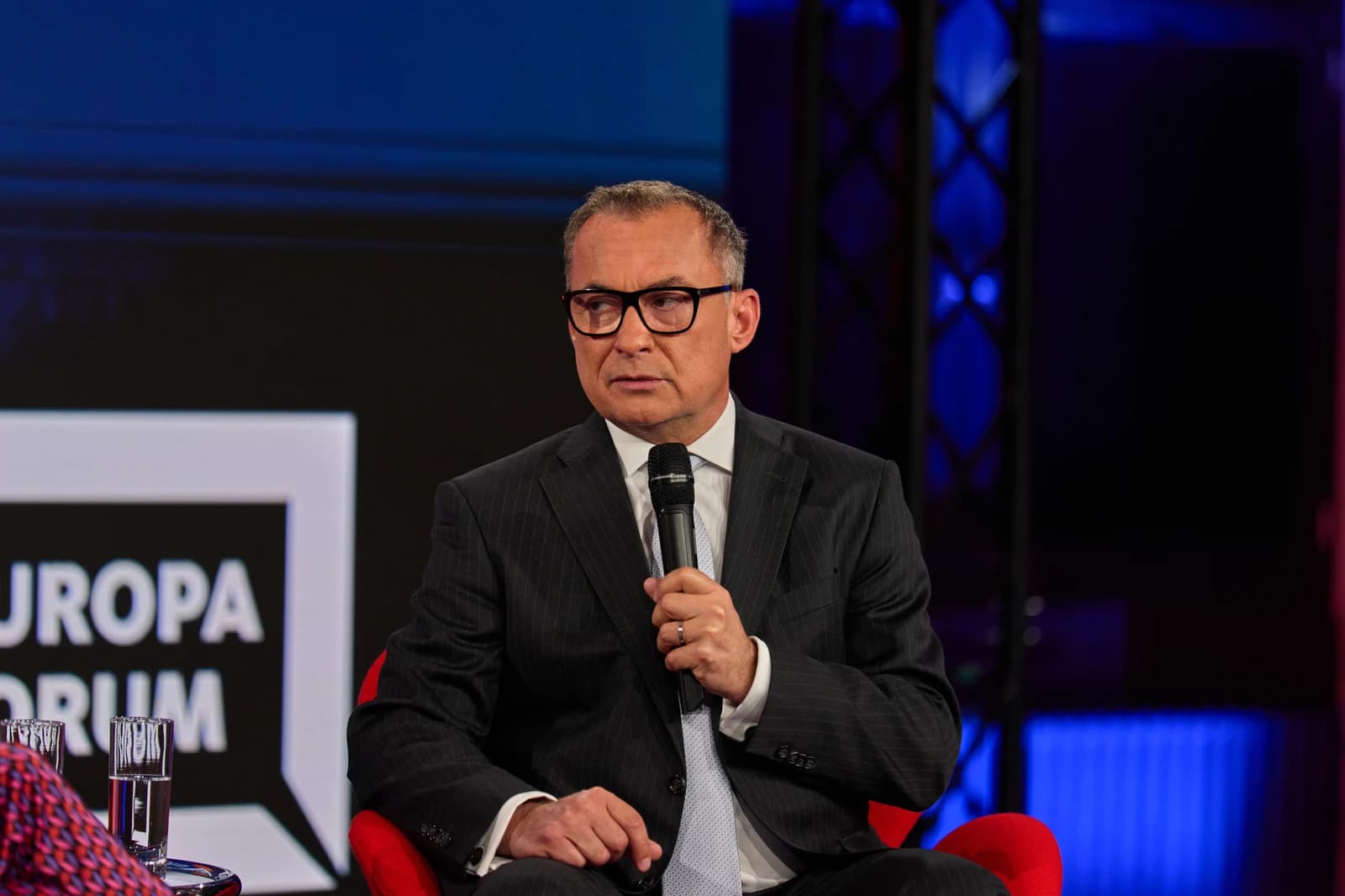 Joachim Nagel, President of Bundesbank, holding a microphone at an event.