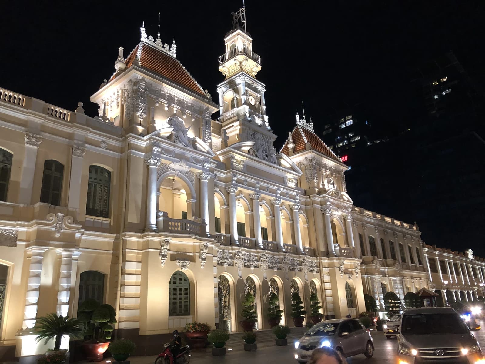 Ho Chi Minh City People's Council building facade illuminated at night.