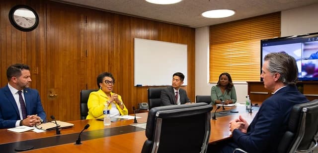 Secretary Marcia Fudge with California Governor Gavin Newsom and other officials at a conference table.