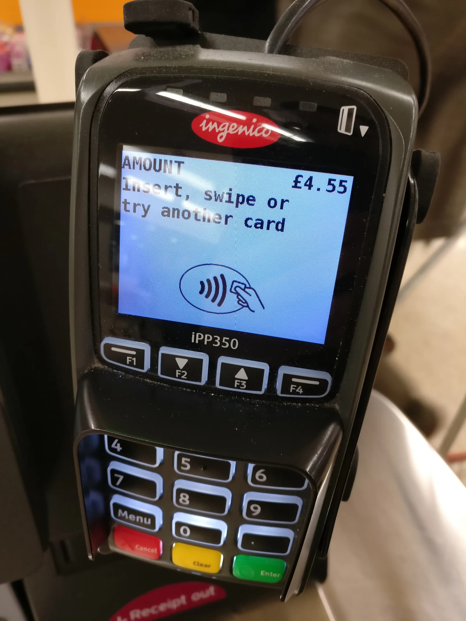 Ingenico iPP350 payment terminal with a screen showing £4.55 and payment options.