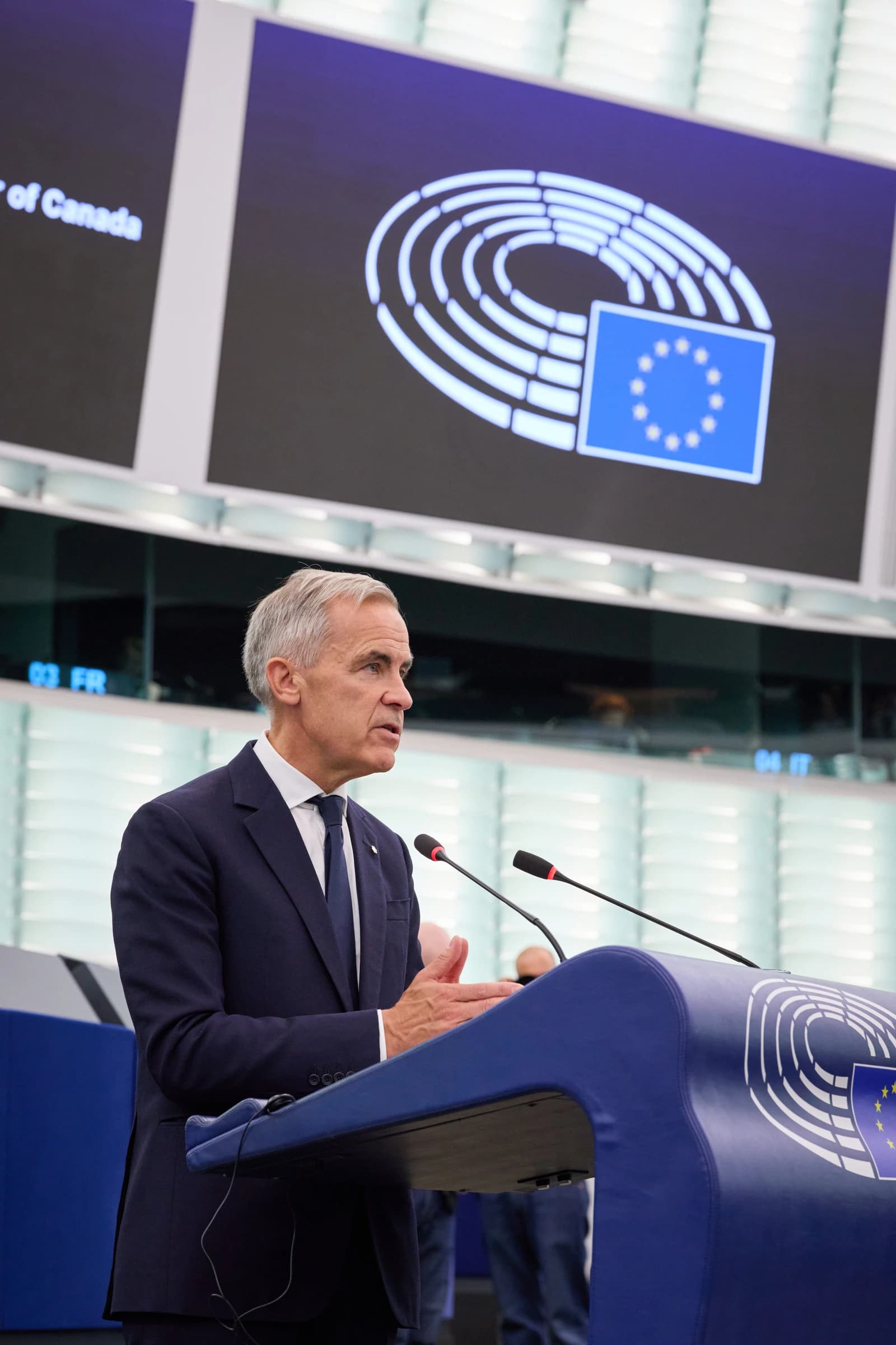 Mark Carney, former Governor of the Bank of England, speaking at a podium.