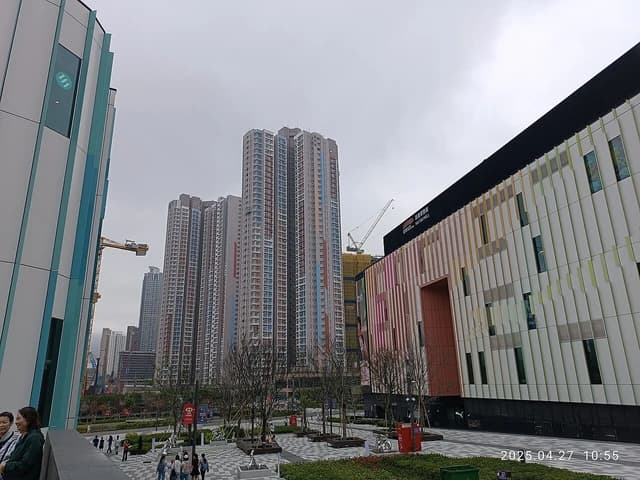 High-rise residential buildings and a shopping mall in Kai Tak Development area.