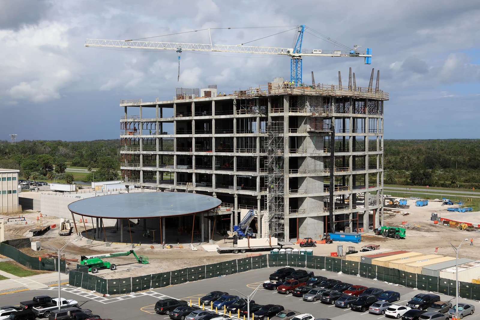 Aerial view of a multi-story building under construction with a large crane.