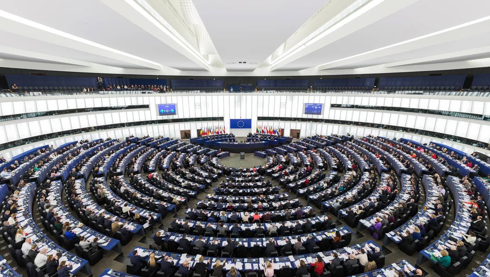 High-angle view of members gathered in the European Parliament Hemicycle during a session.
