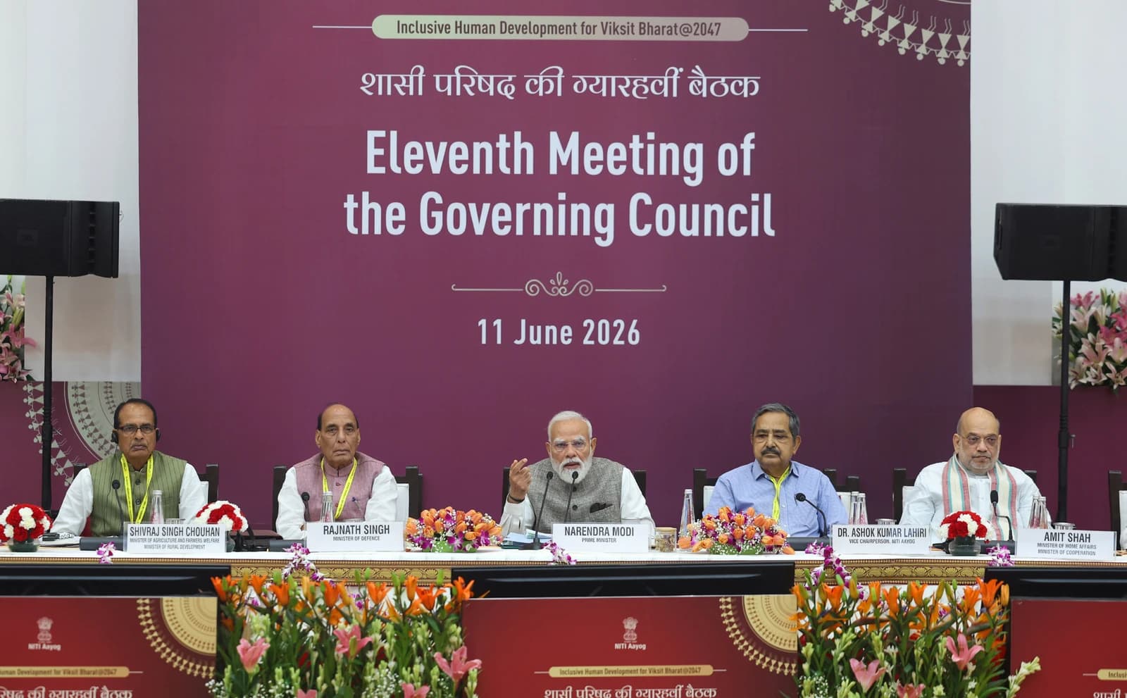 Narendra Modi, Prime Minister of India, speaks at a conference table with other officials.