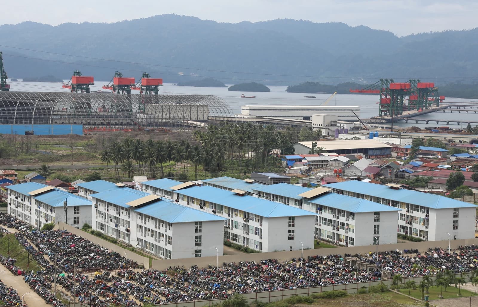 Aerial view of Morowali Industrial Park showing housing, facilities, and coastline.