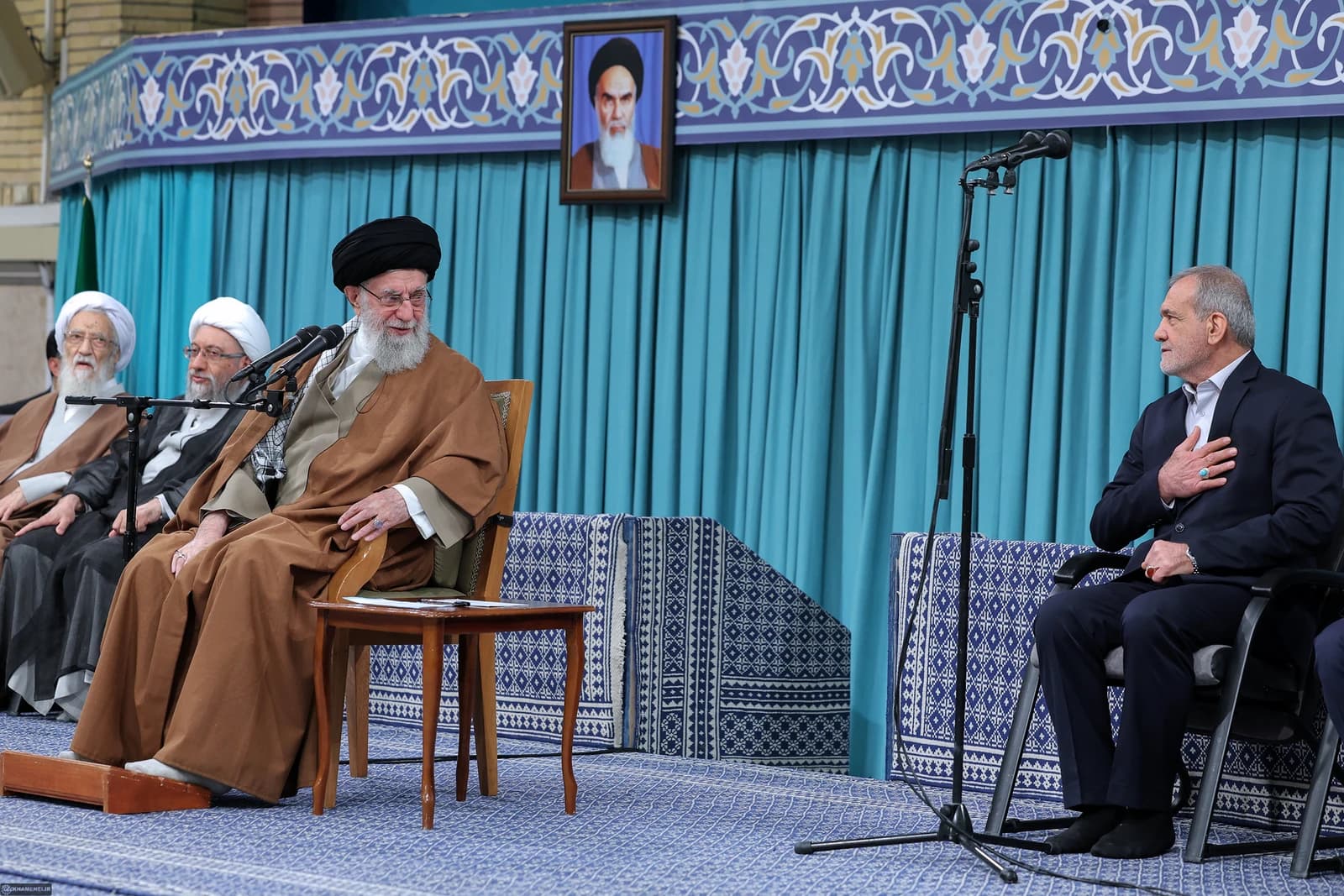 Ayatollah Ali Khamenei, Supreme Leader of Iran, sitting with other officials during a meeting.