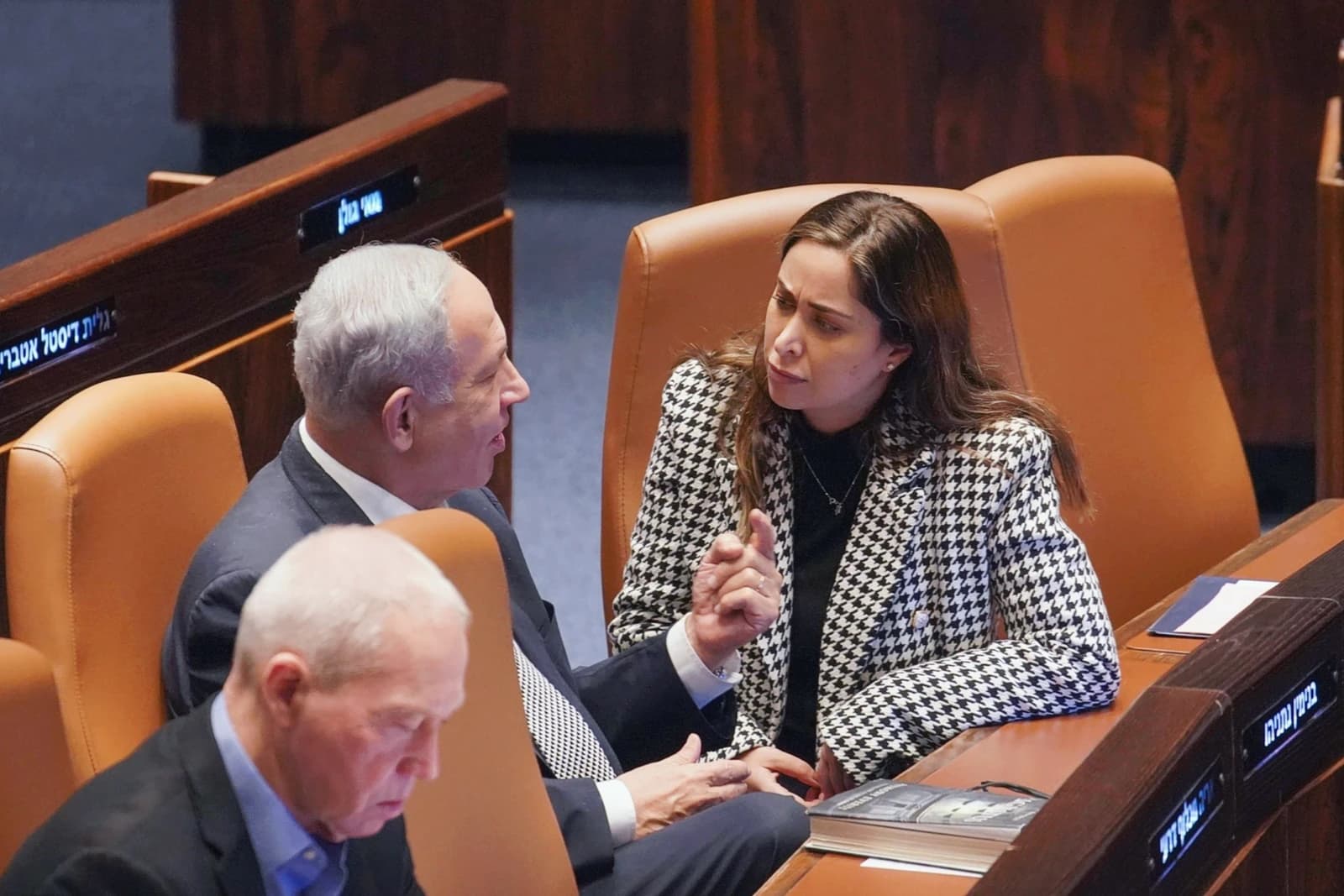 Benjamin Netanyahu, Prime Minister of Israel, conversing with May Golan, a politician, in a parliament chamber.