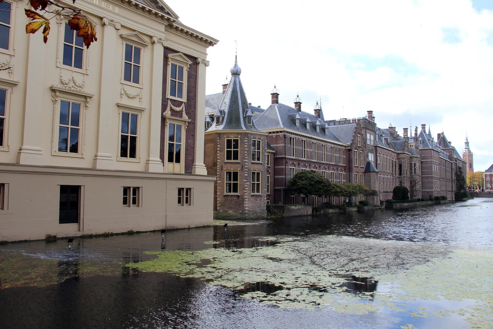 Mauritshuis museum and Binnenhof government buildings reflected in the water of a canal in The Hague.