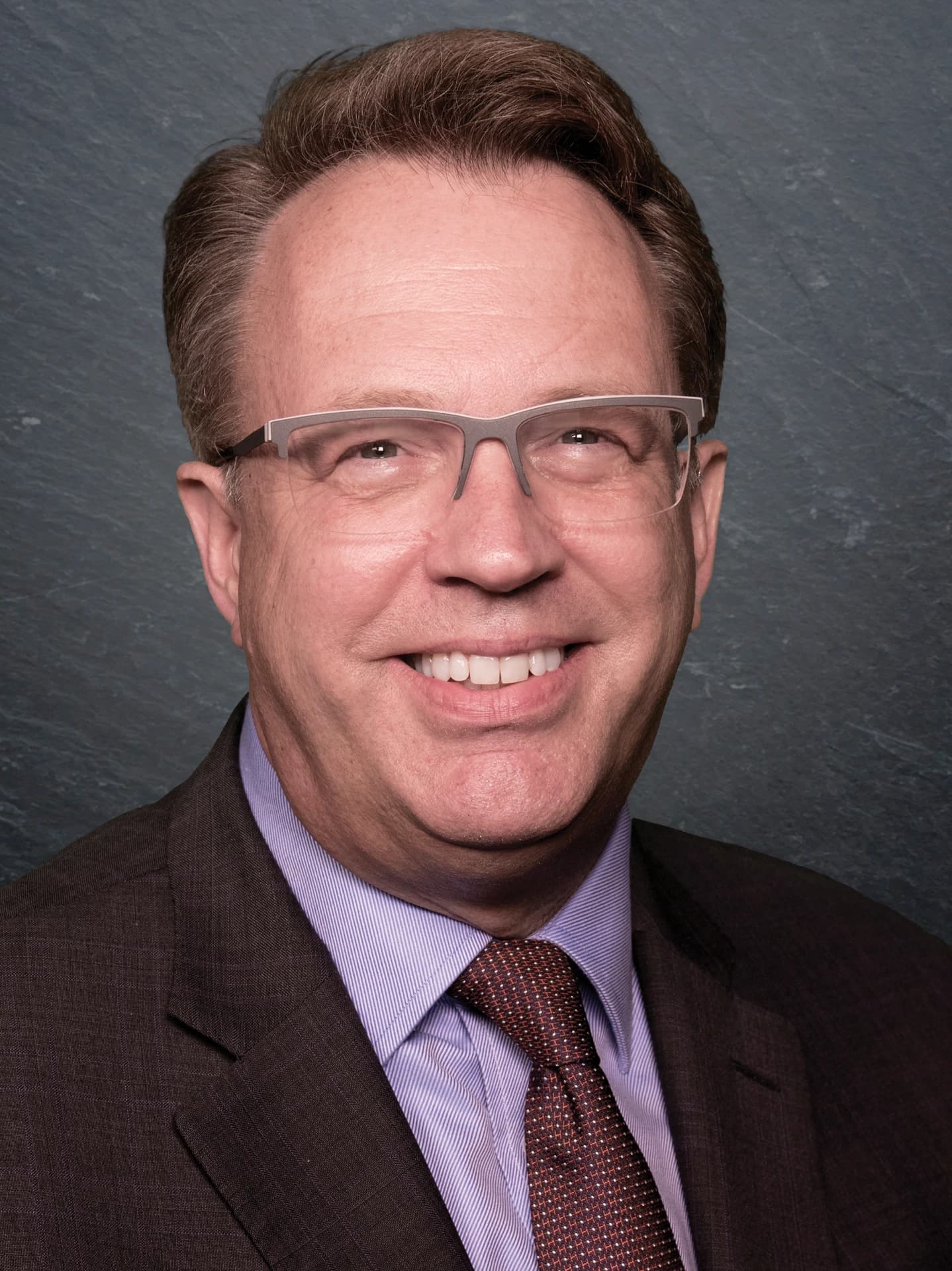 John C. Williams, President and CEO of the Federal Reserve Bank of New York, smiling at the camera.