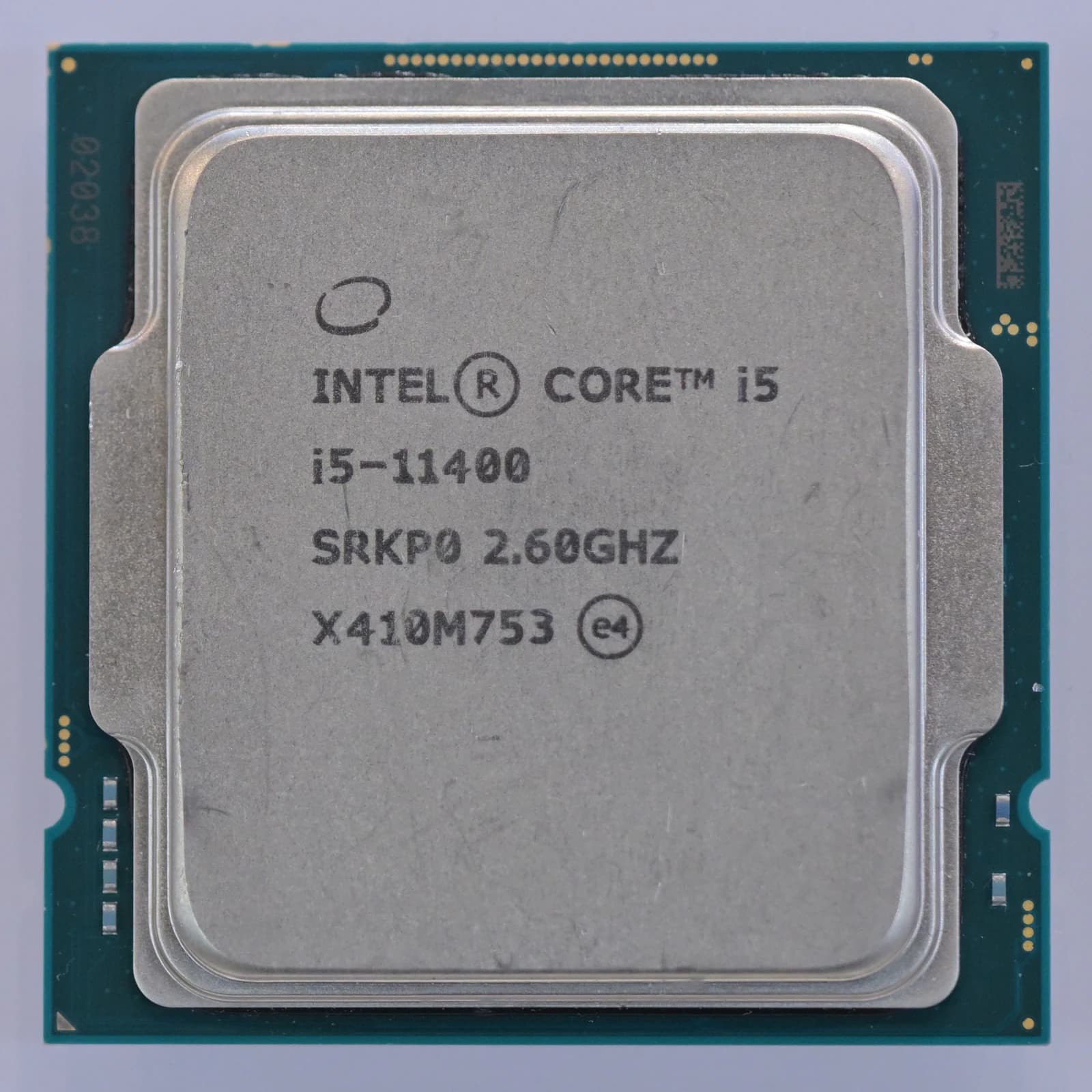 An Intel Core i5 11400 processor chip with its specifications visible.