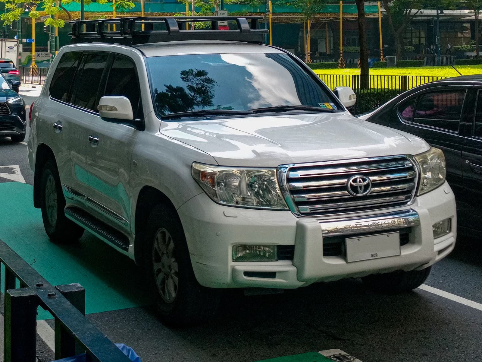 White 2010 Toyota Land Cruiser GX-R V8 parked on a city street.