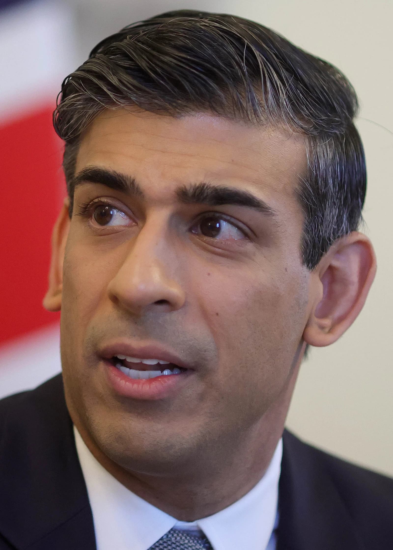 Rishi Sunak, Chancellor of the Exchequer, looking right with mouth slightly open.