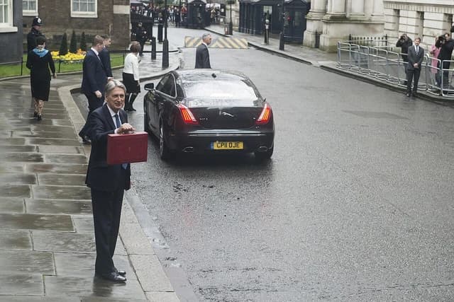 Philip Hammond, former Chancellor of the Exchequer, holding the red Budget box at Downing Street.