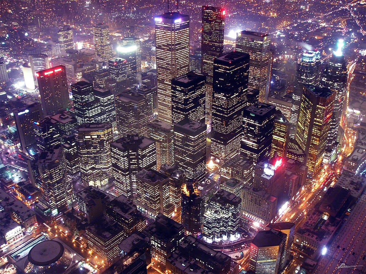 Aerial view of the Toronto financial district at night, illuminated skyscrapers.