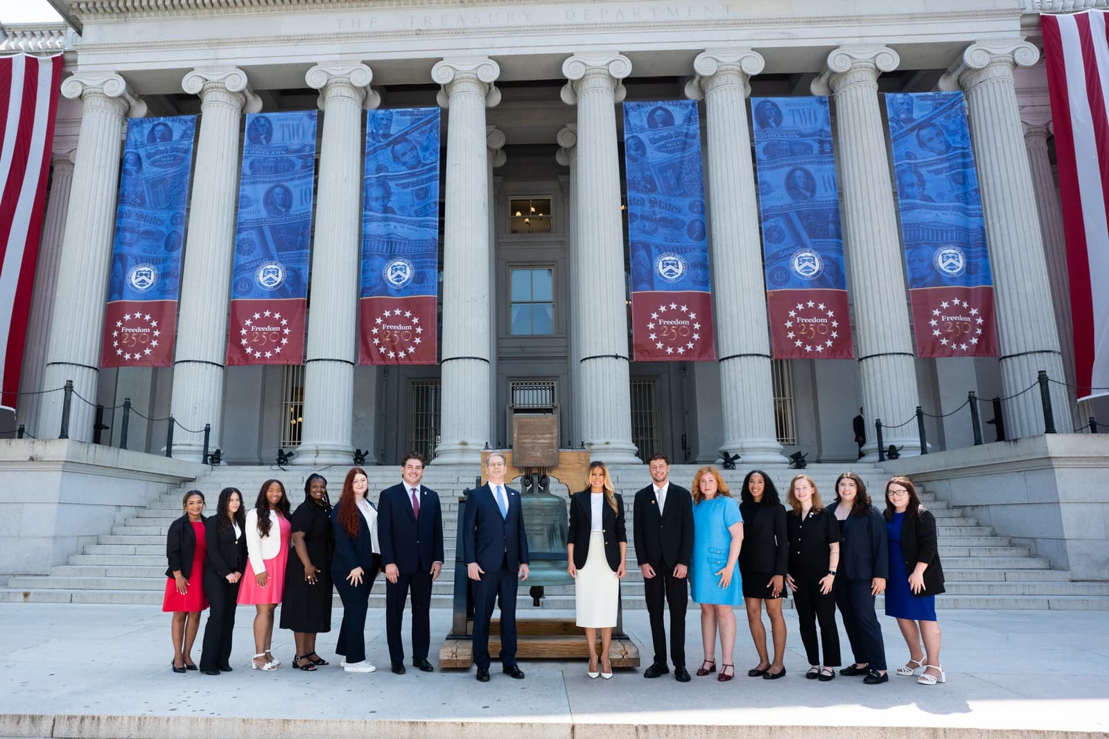 Group of people, including Department of the Treasury officials, standing outside the Treasury Department building in Washington, D.C.