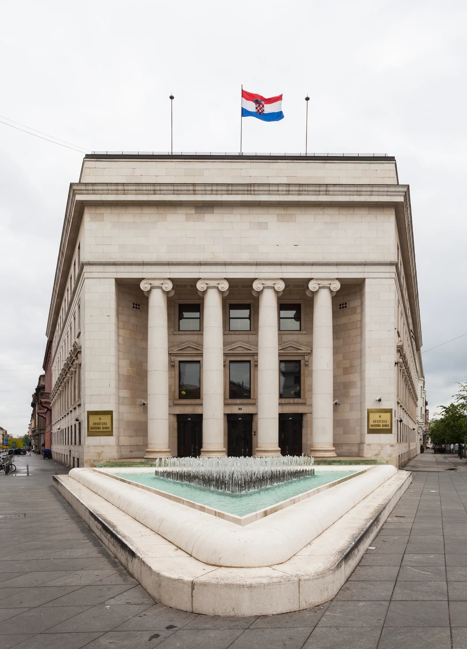 Exterior view of Croatian National Bank building in Zagreb, Croatia, with a Croatian flag flying.