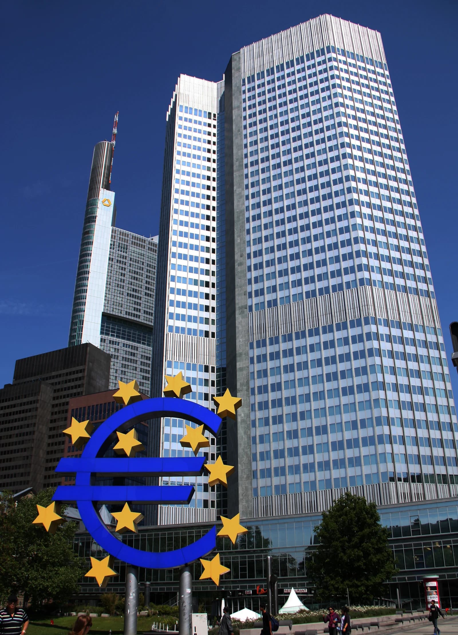 Euro sculpture with twelve yellow stars in front of the Eurotower in Frankfurt.