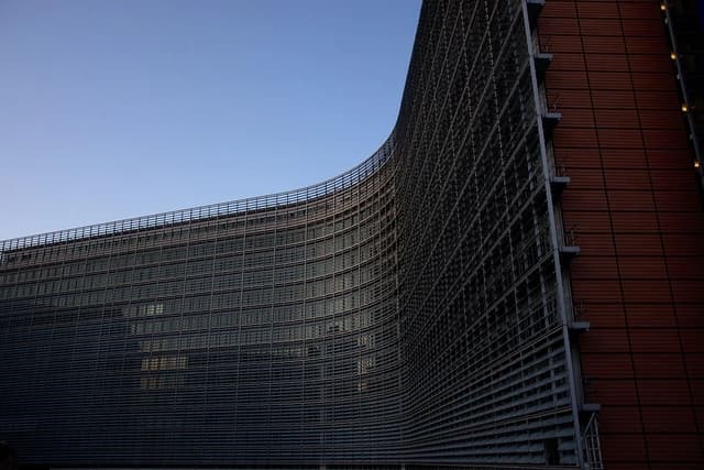 Exterior facade of the Berlaymont Building, headquarters of the European Commission, under a clear sky.