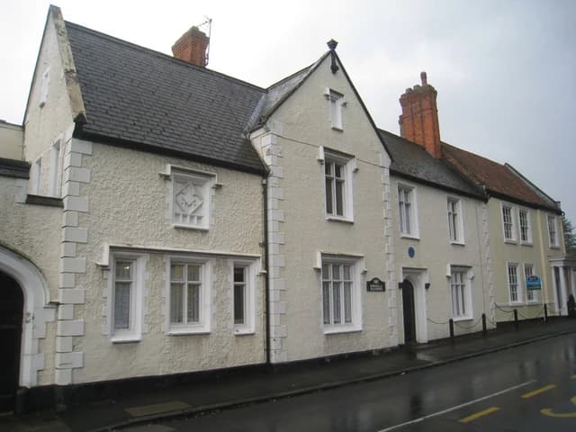 Kirkella Mansions and No. 4 Church Lane on a street on a cloudy day.