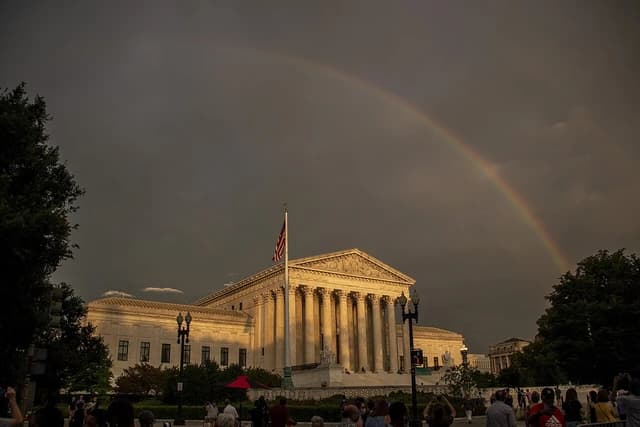 A double rainbow arches over the US Supreme Court building in Washington D.C.