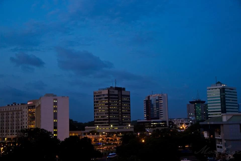 Modern buildings illuminated at dusk in Accra, the capital city of Ghana.