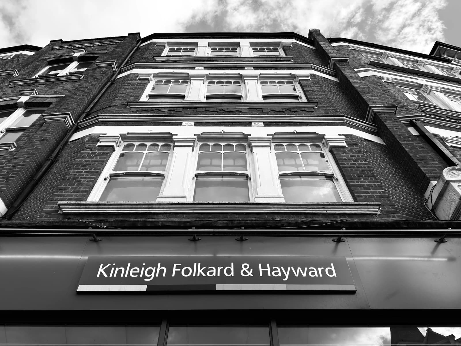 Kinleigh Folkard & Hayward building exterior with windows and signage.