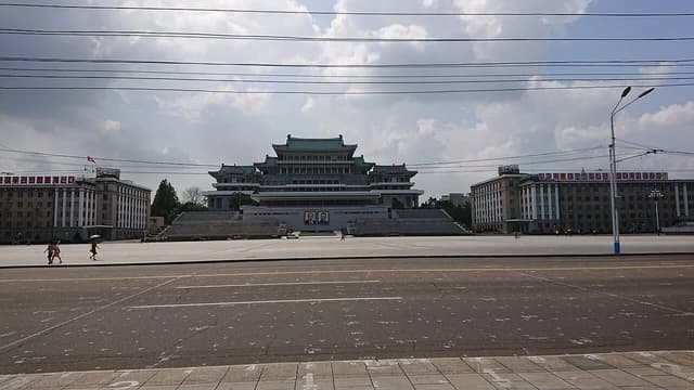 Buildings and a large paved square, Kim Il-sung Square, in Pyongyang, North Korea.