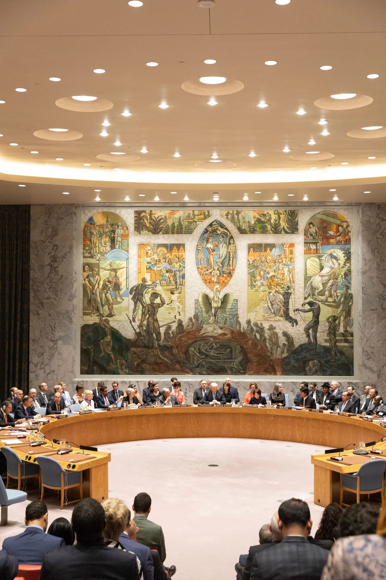 Donald Trump, President of the United States, seated at a long table during a UN meeting.