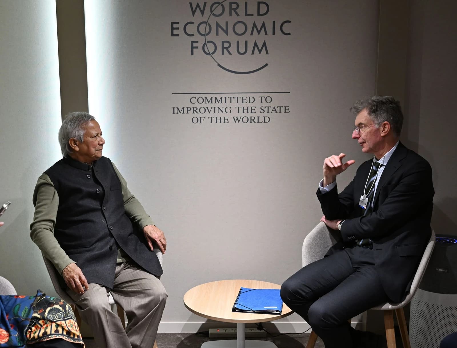 Christoph Heusgen and Muhammad Yunus sit opposite each other at the World Economic Forum.