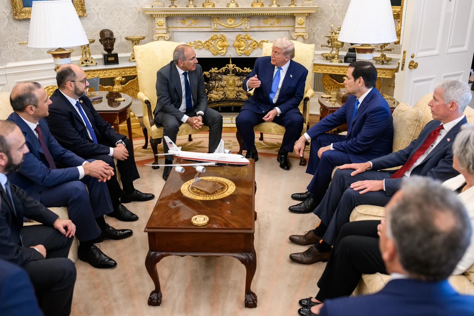 President Donald Trump speaking in a room with President Ilham Aliyev and Prime Minister Nikol Pashinyan.