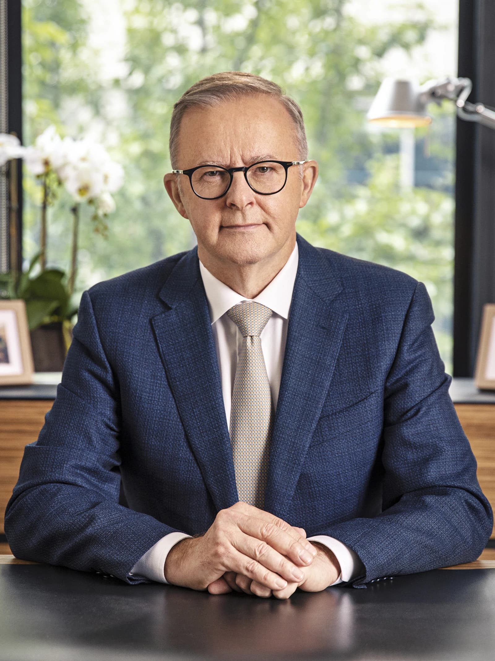 Anthony Albanese, Prime Minister of Australia, sitting at a desk indoors.