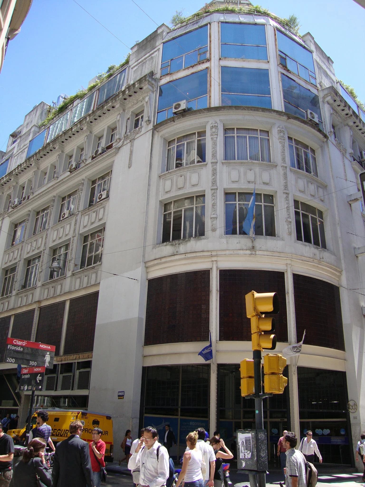 Banco Ciudad headquarters building, a multi-story structure with people walking outside.