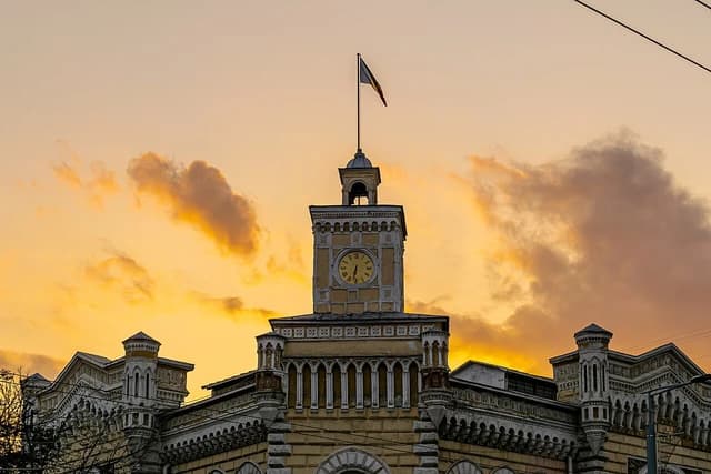 City Hall building in Chisinau, Moldova, featuring a clock tower and a flag.