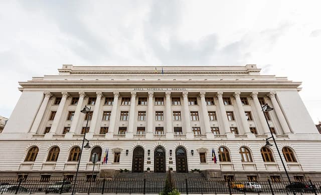 The neoclassical building of the National Bank of Romania with columns and archways.