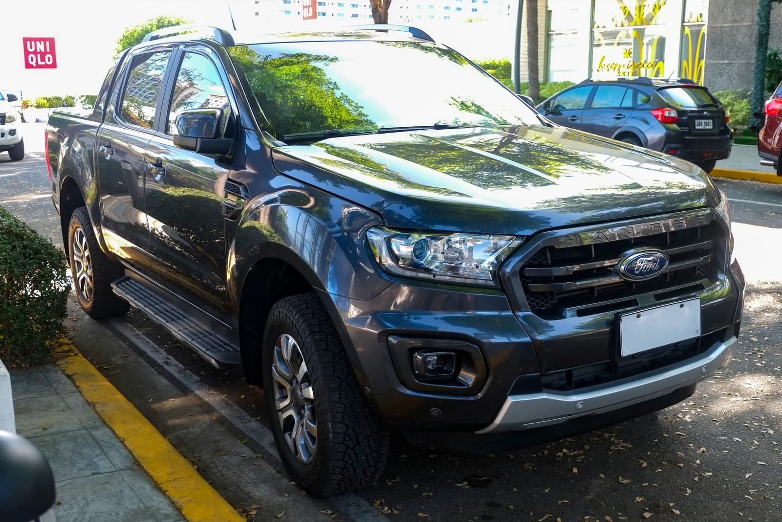 Ford Ranger P375 2.0 Bi-Turbo Wildtrak 4x4 pickup truck, Meteor Gray, parked.