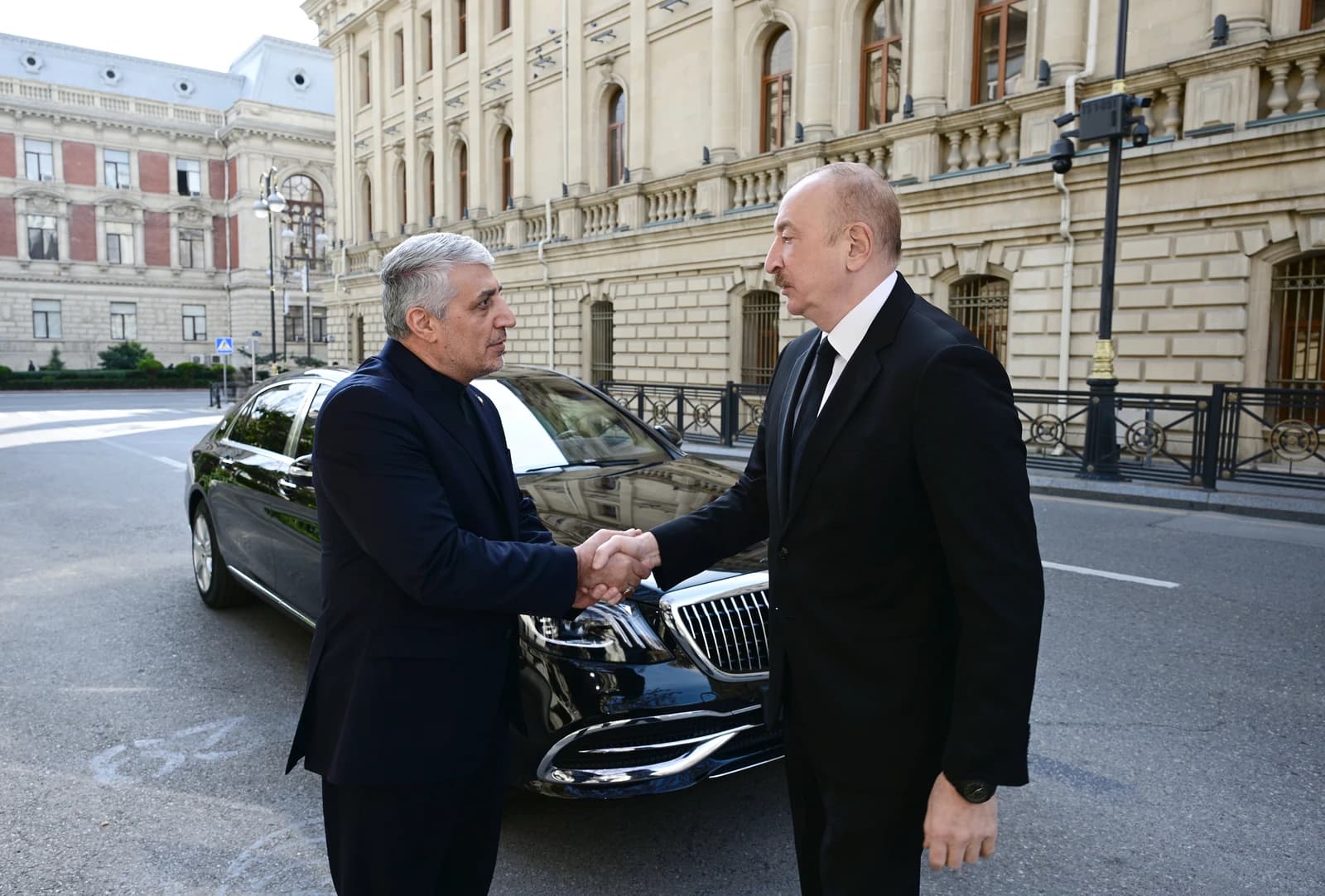 Ilham Aliyev, President of Azerbaijan, shaking hands with an Iranian official.