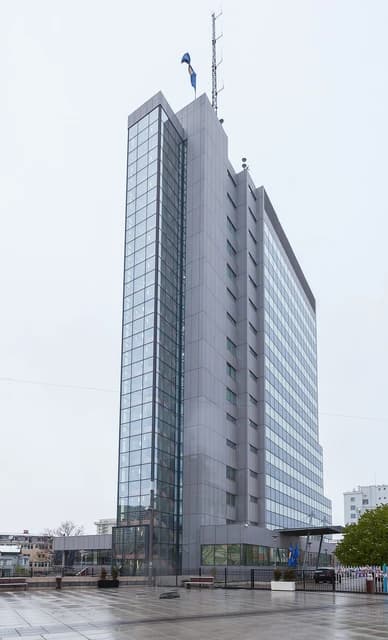 Exterior view of the government building in Pristina, Kosovo, under an overcast sky.