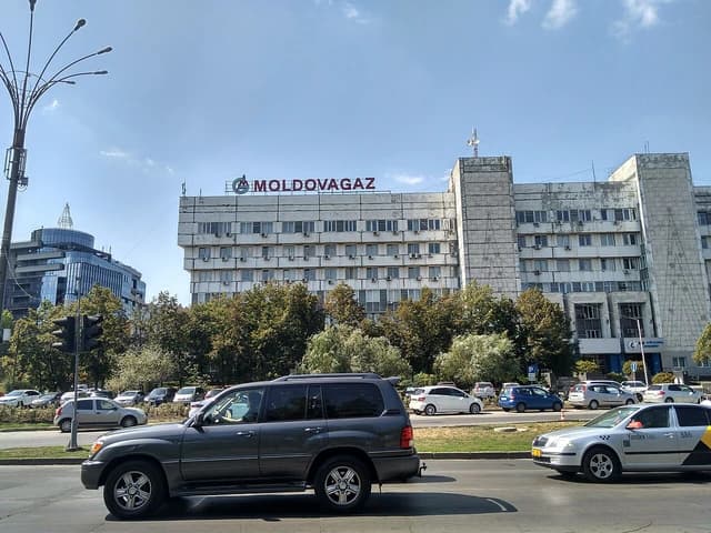 Moldovagaz Headquarters building exterior in Moldova with traffic in the foreground.